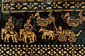 Wat Xieng Thong temple in Luang Prabang, Laos. Detail of the  intricate gold stencilling on black lacquer that decorate the walls of the sim. 